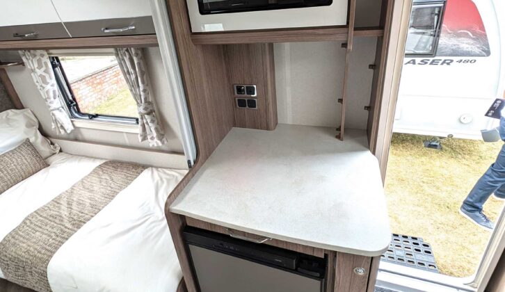 The microwave sitting above the fridge