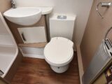 The washroom, with a Thetford cassette loo with electric flush and radiator, and a deep handbasin