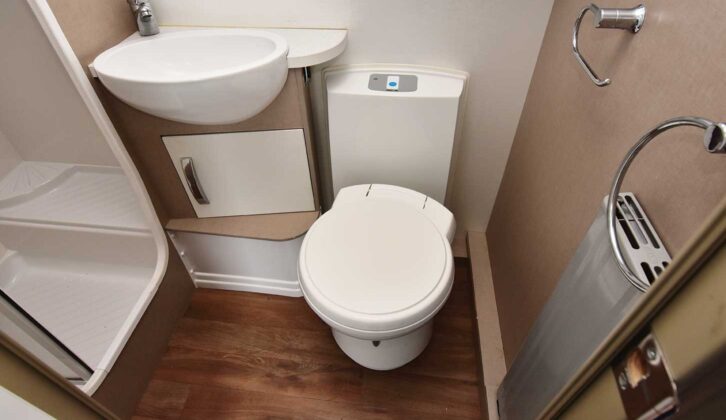 The washroom, with a Thetford cassette loo with electric flush and radiator, and a deep handbasin