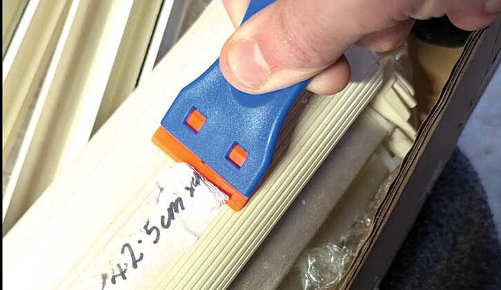 Using a scraper to remove the price tag