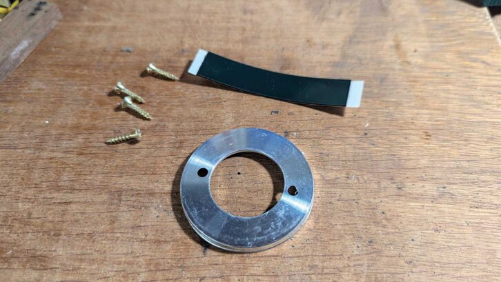 The sticky pad, screws and base plate