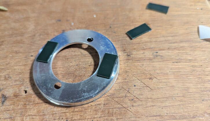 A heavy-duty sticky tab cut into pieces and stock to the base plate