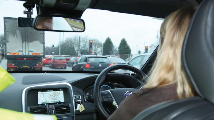 An image from the rear seat's perspective of a car being driven in Coventry looking out through the windscreen