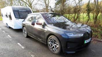 A BMW iX towing a caravan