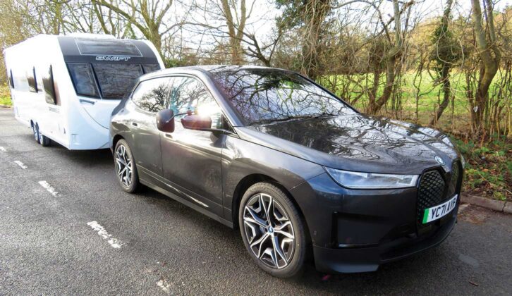 A BMW iX towing a caravan