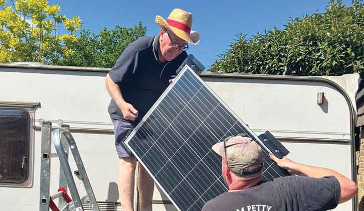 Nigel in the process of installing a solar panel