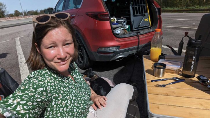Lottie with a picnic set up at a French toll plaza