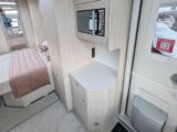 The microwave opposite the kitchen