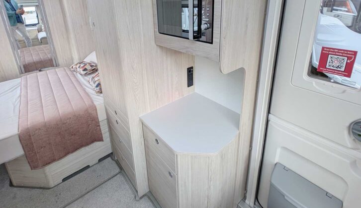 The microwave opposite the kitchen