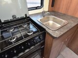 The four-burner hob and the sink in the kitchen