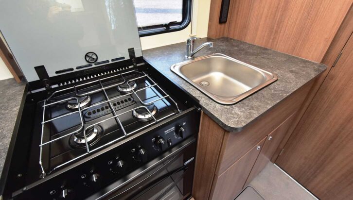 The four-burner hob and the sink in the kitchen