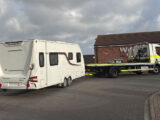 The caravan from the rear, hitched up to a lorry