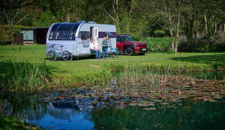 Peter relaxing at a campsite as he talks to a member of staff