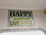 A sign saying "Happy campers live here"