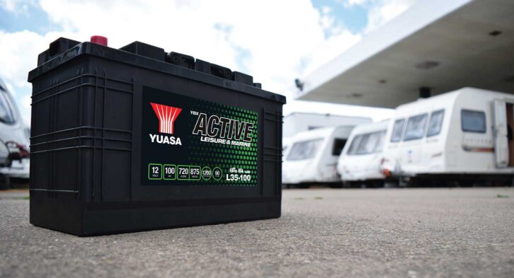 A Yuasa leisure battery with caravans in the background