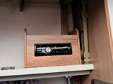 The fixed radio in an overhead locker