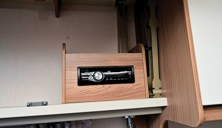The fixed radio in an overhead locker