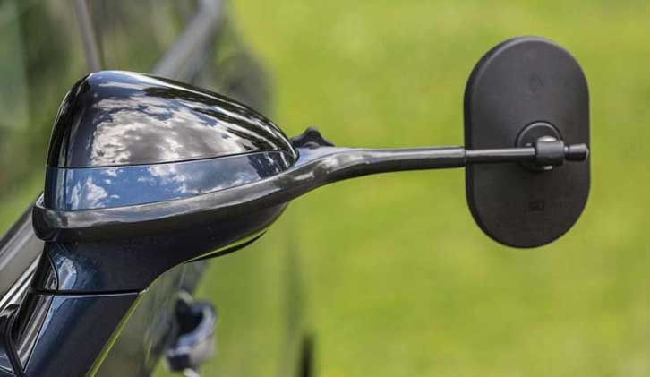 An EMUK towing mirror attached to a car