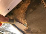 Using a flat scraper and chisel to remove the old floor section