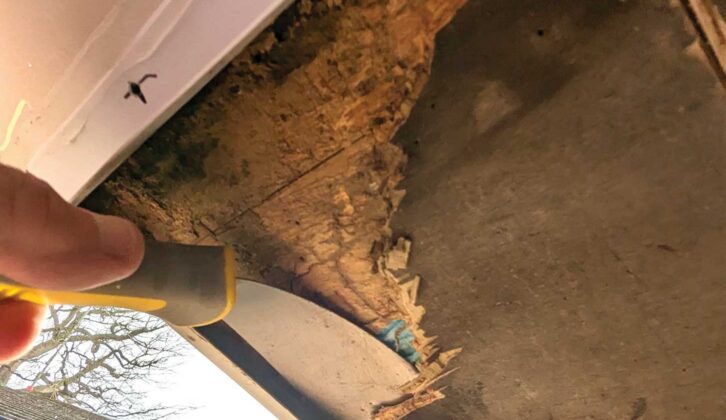 Using a flat scraper and chisel to remove the old floor section