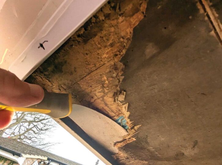 Using a flat scraper and chisel to remove the old floor section
