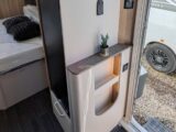 The shelving unit by the door