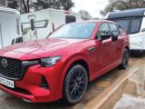 The Mazda CX-60 hitched up to a car