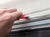 Pushing the trim into the channel with the roller end