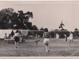 Club members playing quoits over a net, 1949