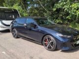 The BMW i5 M60 xDrive Touring hitched up to a caravan
