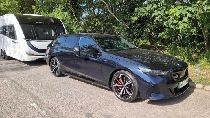 The BMW i5 M60 xDrive Touring hitched up to a caravan