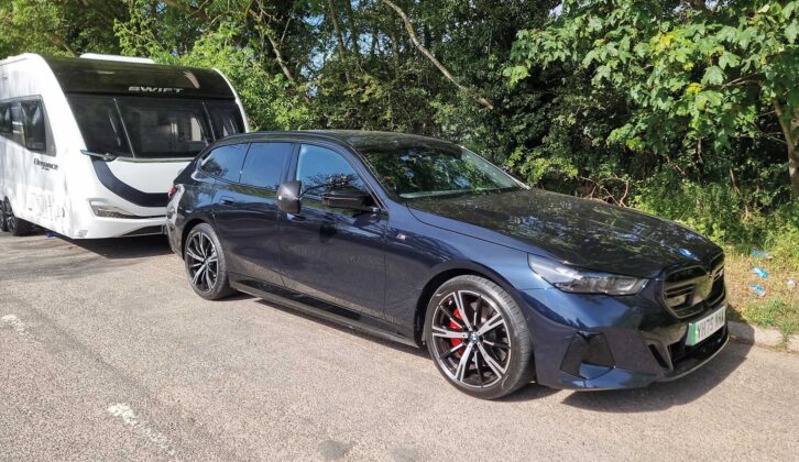 The BMW i5 M60 xDrive Touring hitched up to a caravan