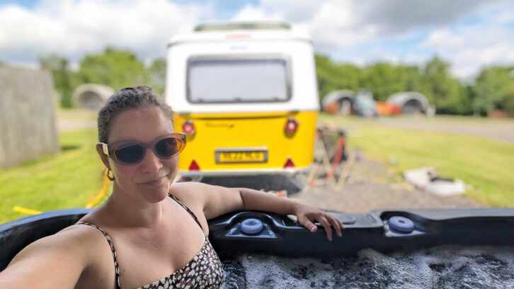 Lottie in the hot tub with the Eriba in the background