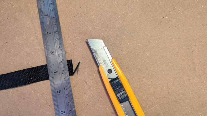A craft knife next to a ruler